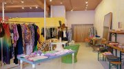 Oumille's Cambridge store interior with colorful clothing racks and display tables.
