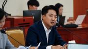 Lee Junseok, a South Korean politician, is seated at a desk in front of a microphone. 