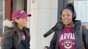 A woman interviews a Harvard student with a "tiny mic" about her plans for the Harvard-Yale game this year