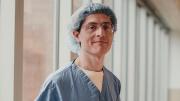 Benjamin Rapoport in surgical scrubs by a hospital window.