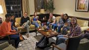 Six undergraduates and curator Joachim Homann gathered in a cozy lounge, discussing art and exhibit design.
