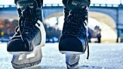 A photograph of ice hockey skates seen from the ice