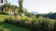 White house with gardens and hills in the distance