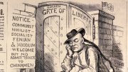 Man sits outside "Golden Gate of Liberty" under sign that reads, "“Notice—communist, nihilist, socialist, Fenian & hoodlum welcome but no admittance to Chinamen.”
