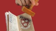  passport with a Harvard shield being stamped "No entry" 