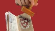  passport with a Harvard shield being stamped "No entry" 