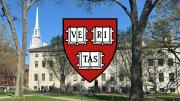 FAS shield in the foreground with University Hall in the background