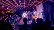 group of students perform on a stage in front of a crowd