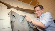 Harvard ichthyologist George Lauder holds up a "sharkskin" swimsuit