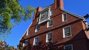 Gold clock on the top of Massachusetts Hall 