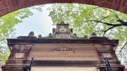 Harvard University entrance with inscription reading "Depart to Serve Better Thy Country and Thy Kind"