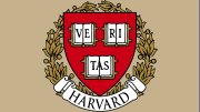 Harvard University crest featuring a shield with books and the words "VERITAS" and "HARVARD".