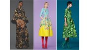 Three models showcase distinct fashions: a floral black gown, a blue top with a floral yellow skirt, and a green dress.
