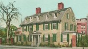Wadsworth House with green shutters and red brick chimneys, surrounded by trees and other buildings.