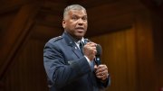U.S. Air Force Lieutenant General Richard Clark in a military uniform speaks passionately into a microphone on stage.