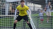 Soccer player and goalkeeper Matt Freese standing in front of the net