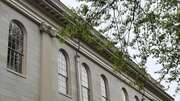 University Hall exterior with ornate windows and greenery.