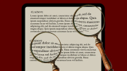A digital tablet displaying text, with two magnifying glasses overlapping it.