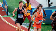 Runners compete on a track, with a Harvard athlete in the foreground and others behind.