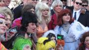 Donning ostentatious outfits, members of the troupe pose for photos before the parade.