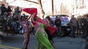 Hasty Pudding members danced and cheered on a windy street corner in Harvard Square as the parade began.