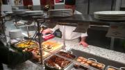 Vegan muffins, hash, bacon, and other plant-based options are served at a cafeteria counter