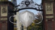 n95 mask in the foreground, Harvard Yard in the background 