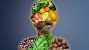 Silhouette of a human body comprised of food groups: fruit, nuts, legumes, vegetables, whole grains