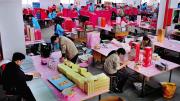 Shenzhen: leased migrant workers (in blue clothes) at a paper factory in the booming southern Special Economic Zone 