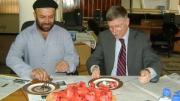 Farivar enjoys watermelon with a U.S. diplomat.