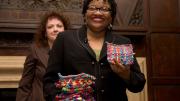Beverly McIver with potholders made by her sister, Renée, at the Harvard Club of New York event. Filmmaker Jeanne Jordan is in the background.