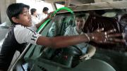Visiting a Mahindra First Choice Wheels used-car dealership in Mumbai to advise the chain on better connecting with its customers, first-year M.B.A. students left no detail unnoticed. Here, Mike Diverio gets behind the wheel of a Tata Nano being washed by a worker.
