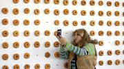 A spectator in front of the <i>Old-Fashioned</i> doughnut wall