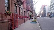 A recent photo of the Hell&rsquo;s Kitchen block on West 56th Street between Ninth and Tenth Avenues, Manhattan, where the cover of the 1957 <i>West Side Story</i> cast album (superimposed in the next image) was shot. Egan spotted the address &ldquo;418 W 56 St&rdquo; on the garbage can to the left of the heroine, Maria. 