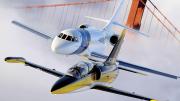An Aero L-39 Albatros (foreground) and Dassault Falcon 2000 over the Golden Gate Bridge