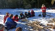 During downtime, students listen to guide Polly Mahoney read about life in the wilderness.