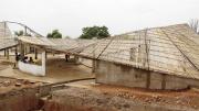 The undulating roof, constructed of local bamboo and thatch, is designed to catch rainwater for community use.