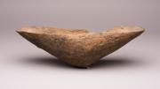 A wood coolamon by an unknown artist