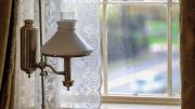 A replica of Dickinson’s small, square writing table sits near a window in her bedroom