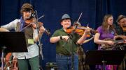 Three fiddlers playing