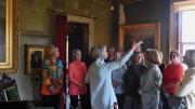 A tour party views works to art at The Evergreens