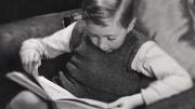 Photo of a young boy reading a book