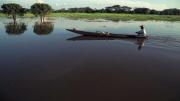 A Colombian fisherman in his boat on one of the Magdalena River's wetlands