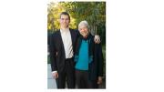 A grandson with his arm around his grandmother