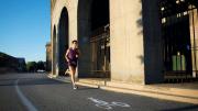 A man runs around the perimeter of Harvard Stadium
