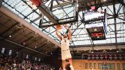 Chris Ledlum dunks the ball in the basket as opposing players trail behind him