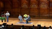 Martin Luther King III and Brandon Terry seated in chairs on a large auditorium stage