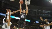 Harvard's Jonah Travis goes up for a layup.