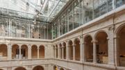 Natural light streams in from a glass roof above the fifth level.