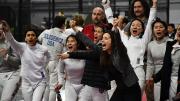 Coaches and members of Harvard's women's fencing team celebrate